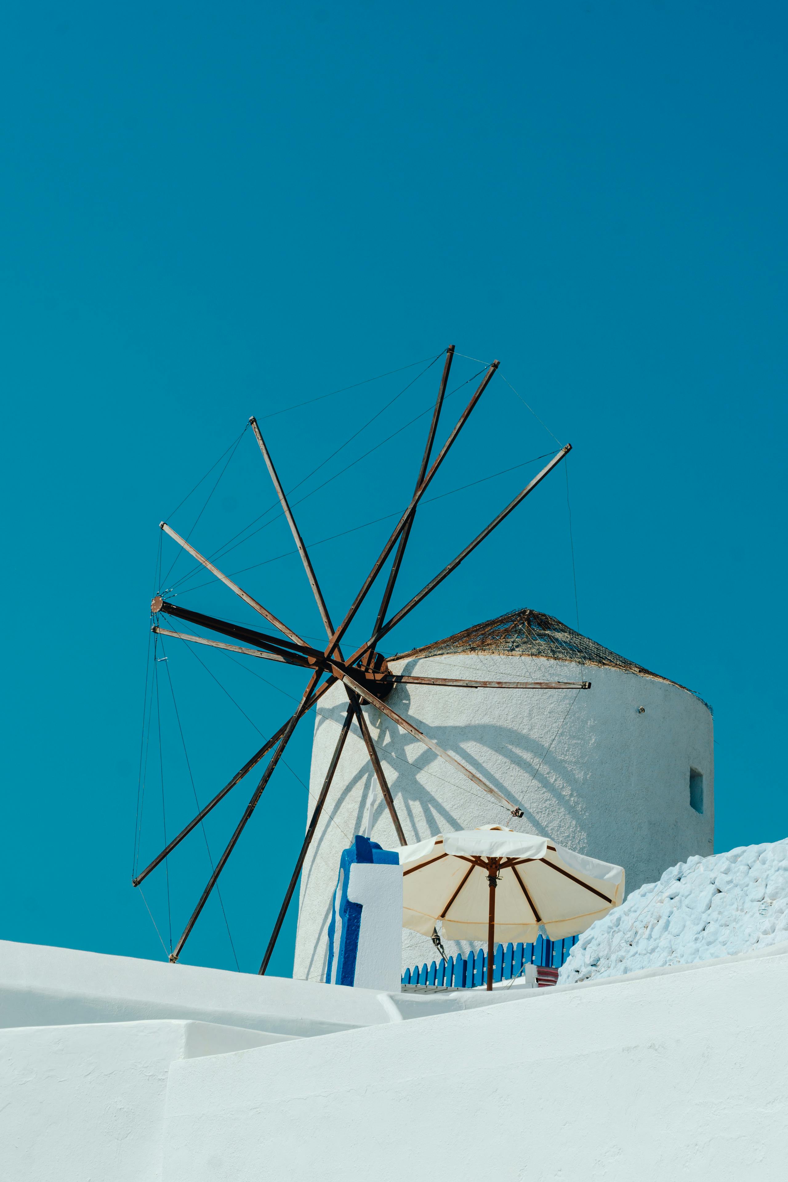 Traditional Santorini windmill at sunset representing island history