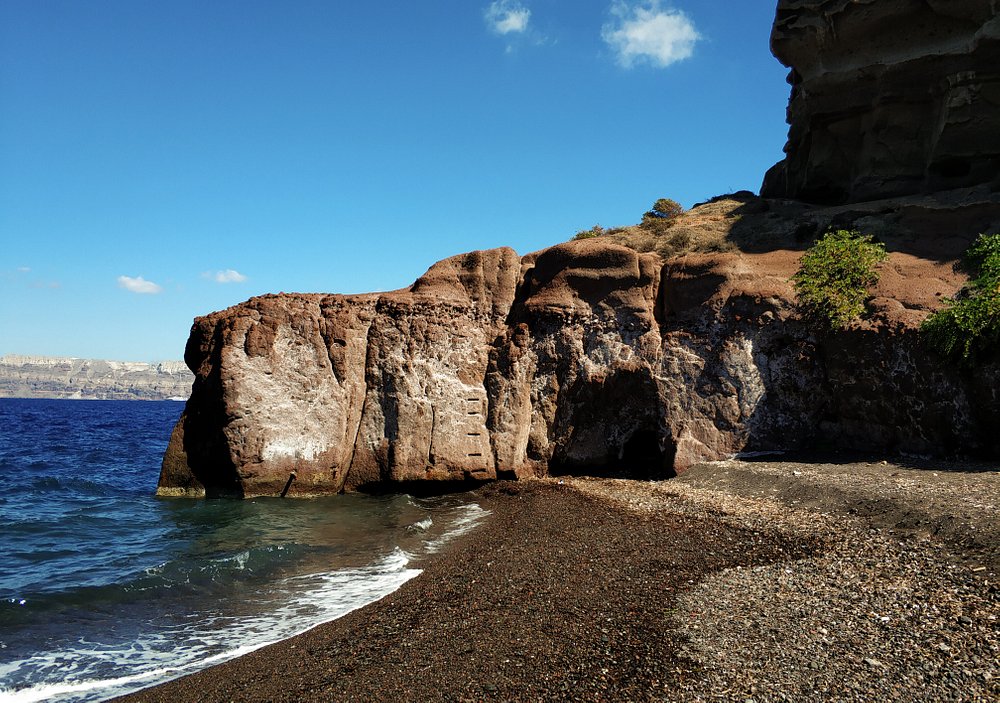 Caldera Beach Santorini view of the volcano and steep cliffs from the black sand shore