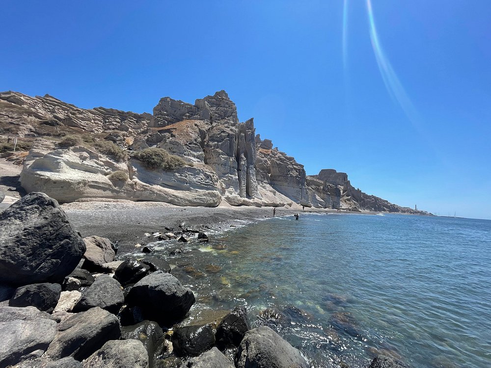Eros Beach Santorini secluded beach with dramatic canyon cliffs and luxury lounge area