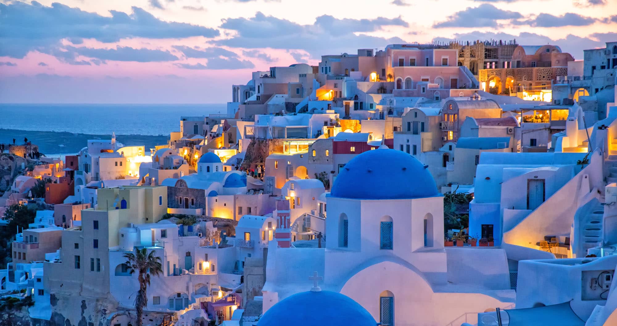 Santorini villages with white buildings and blue domes